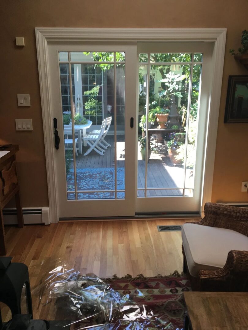 A room with two sliding glass doors and a wooden floor.