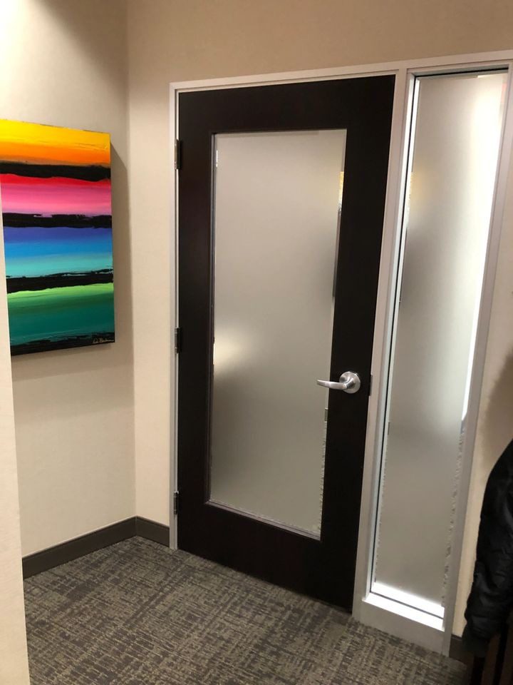 A door with frosted glass in the middle of a room.