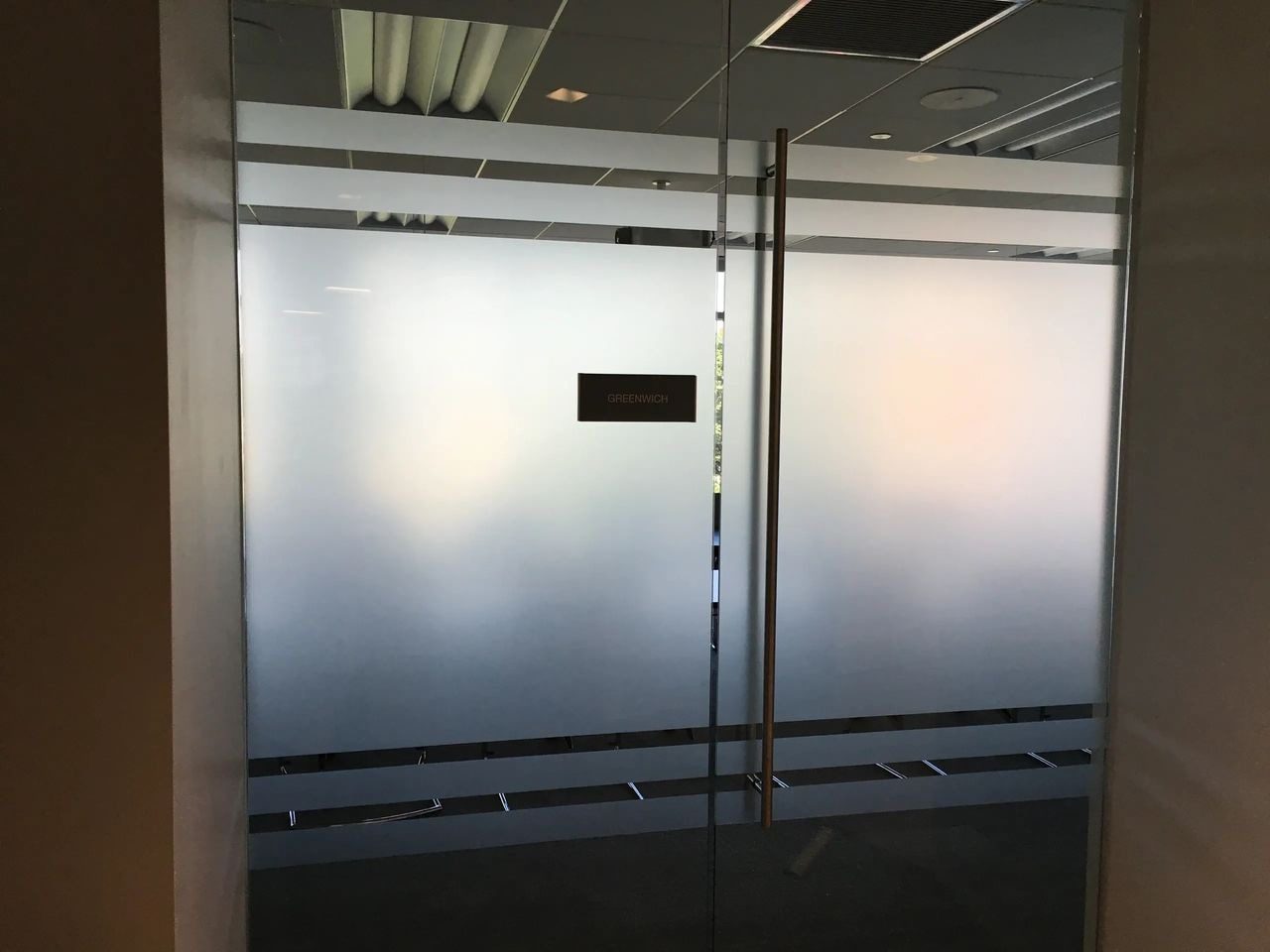 A glass door with a sign on it