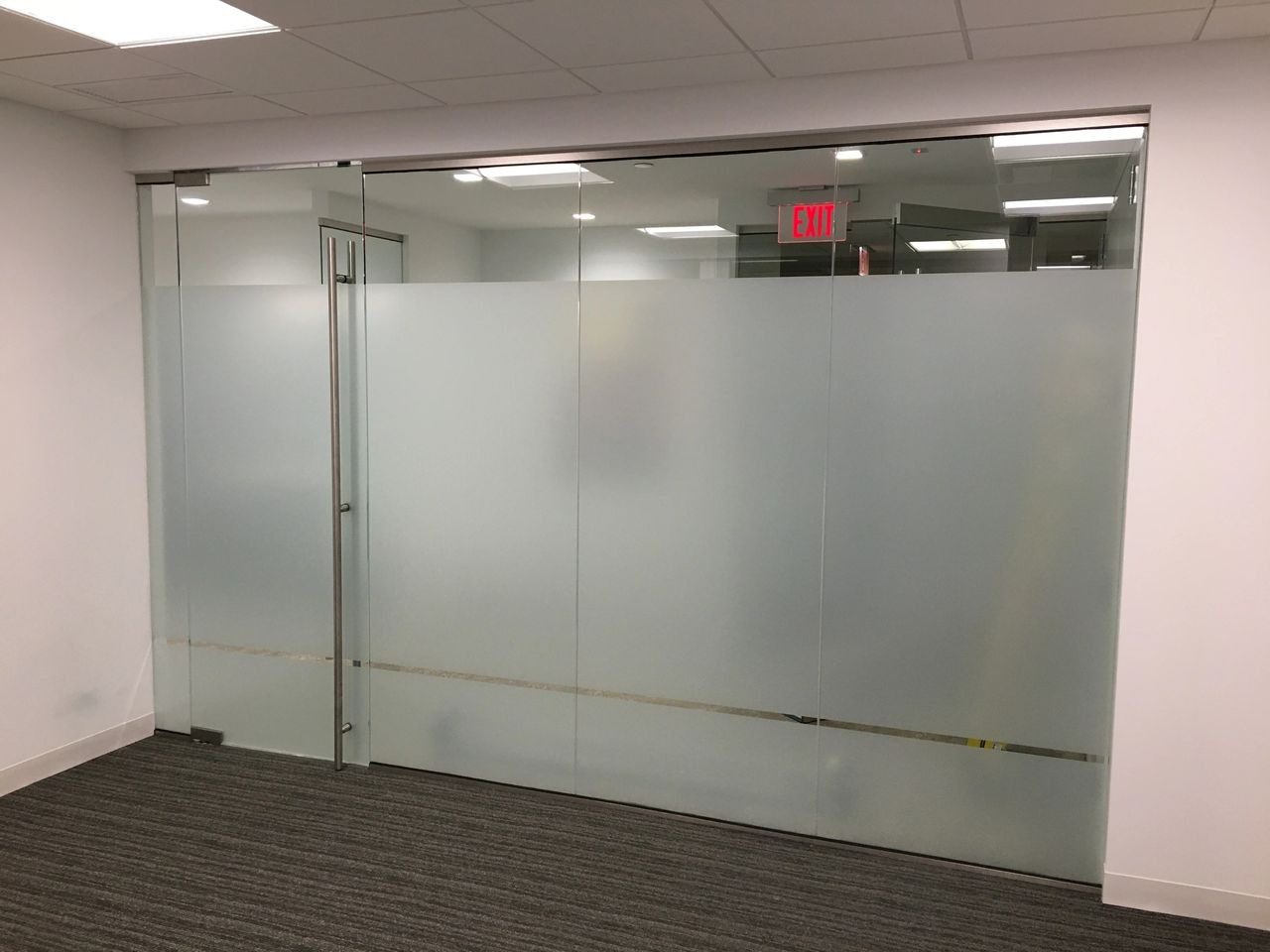 A room with glass walls and a door.