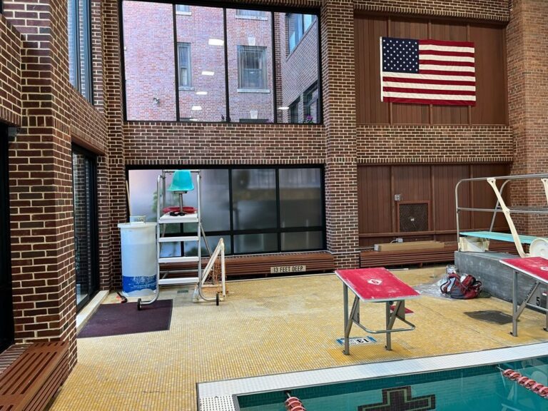 A pool with an american flag on the wall.